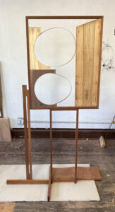 Wooden stand with circles, 2023 varied wood, Sapele frame 72″ x 32″ x 24″